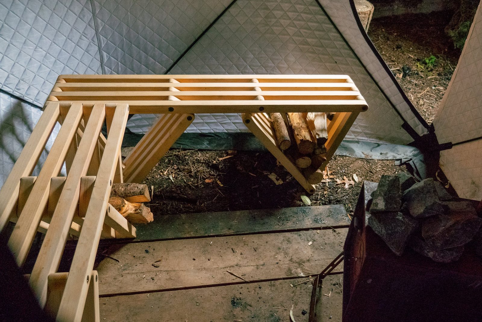 Roomy sauna tent interior with wooden benches